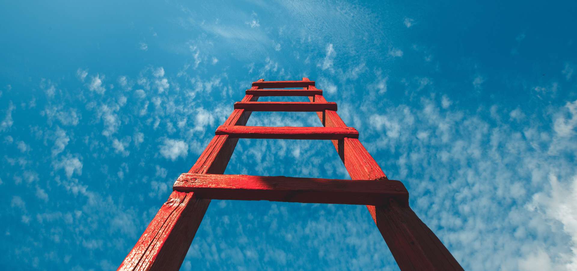 Red wooden staircase against blue sky
